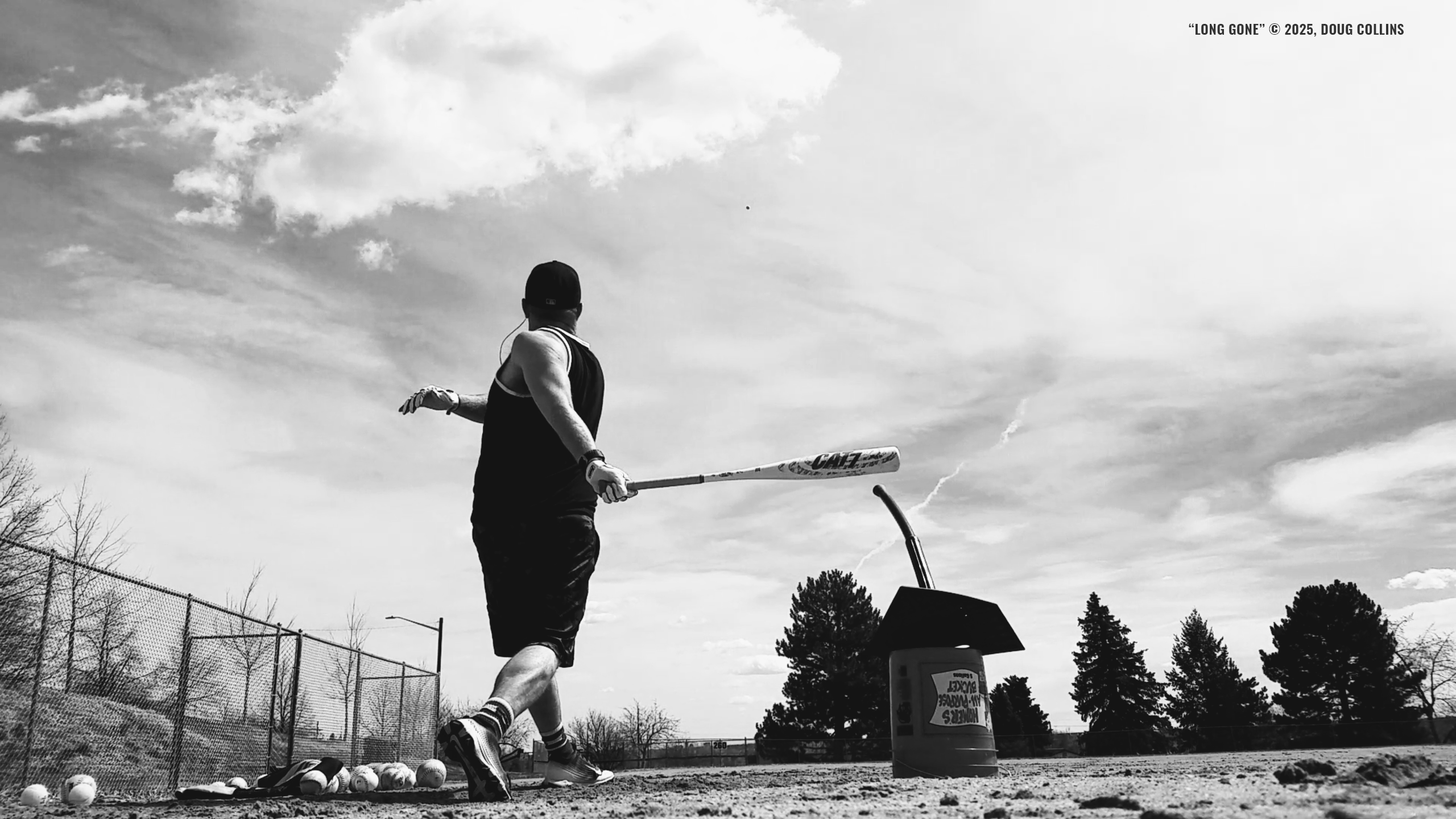 Taking batting practice, in black and white.